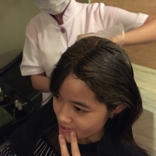 The paste being applied on the hair.